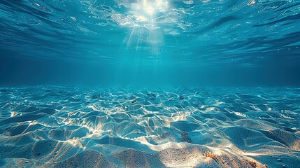 Wall Mural - Seabed sand with blue tropical ocean above, empty underwater background with the summer sun shining brightly, creating ripples in the calm sea water