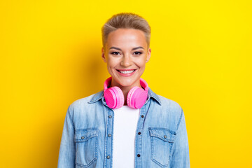 Wall Mural - Photo portrait of attractive young woman headphones listen music wear trendy jeans clothes isolated on yellow color background