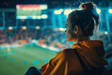 Fototapeta Natura - Woman Watching Soccer Game in Stadium