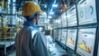 © visoot - An engineer standing in front of computer screens showing some graphs related to energy generation inside of a nuclear power plant. Generative AI.