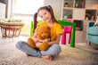© deagreez - Photo portrait of charming small girl sit floor hug favorite toy playing wear trendy yellow outfit children kindergarten playroom