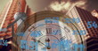 Image of stock market and keys and house with clock over cityscape