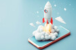 © VetalStock - Launching a space rocket from a Mobile screen. Mobile business startup concept with space rocket. Launching a successful business