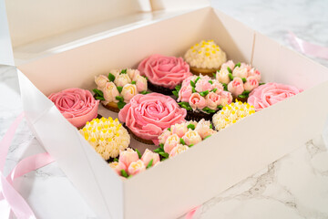 Wall Mural - Delicious Gourmet Cupcakes Topped with Buttercream Frosting Flowers