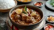 Photography of a massaman curry with chopped beef and potatoes served with rice.