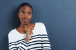 © Katie/peopleimages.com - Thinking, doubt and black woman with mockup in studio for planning, questions or asking on blue background. Why, curious or African female model with emoji guess, problem solving or brainstorming