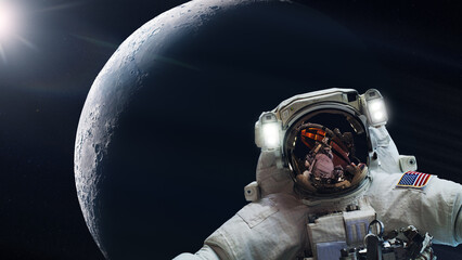 Wall Mural - cosmonaut in outer space on moon planet background. elements of this image furnished by nasa.