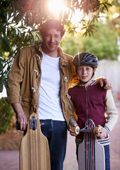 Poster - Father, son and skateboard outdoor in portrait for sports and fun, bonding for love and relationship. Happy people, skating and activity in neighborhood for family time, helmet for safety and hobby