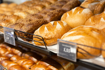 Wall Mural - Loaves of fresh wheat breads on bakery counter