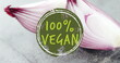 Image of 100 percent vegan text over close up of red onions