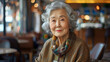 Portrait of senior asian woman smiling in coffee shop, lifestyle