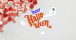 Happy halloween text banner and ghosts icons against close up of candy corns on white surface
