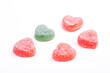 heartshaped candy isoalted on white, one green standing our different