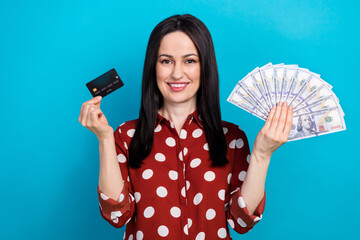 Sticker - Photo portrait of attractive woman hold credit card money fan wear trendy dotted red clothes isolated on blue color background