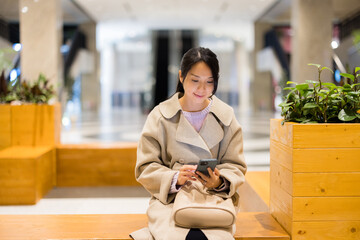 Poster - Woman use mobile phone in shopping center