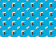 A repeating pattern of a cup of coffee and two briquettes of white creamy ice cream on a blue background