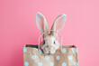 Cute Easter bunny ears in a shopping bag, pastel pink and blue colors with copy space. Generative Ai