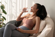 © tonefotografia - Young asian woman in sportswear drinking pure water from glass in living room at home