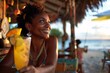 A black woman with a joyful expression, sipping a tropical cocktail at a beachfront cafe, the taste of exotic fruits and the sound of steel drums transporting her to a state of tropical bliss