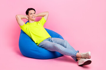 Canvas Print - Full length photo of funky dreamy man dressed yellow t-shirt sitting bean bag arms behind head empty space isolated pink color background