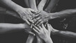 © Kolapatha - A powerful black and white image of diverse hands coming together in a symbol of teamwork and unity.