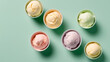Top view of Various of ice cream flavor in bowls on light green background.