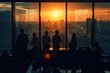 © romanets_v - A silhouette of a business team in an office with a large window overlooking a cityscape. The image captures the team in various postures of interaction and collaboration