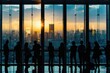 A silhouette of a business team in an office with a large window overlooking a cityscape. The image captures the team in various postures of interaction and collaboration