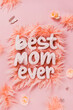 The 3d phrase best mom ever is showcased in bold white letters laid on a soft, pink fluffy surface