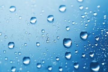 Poster - Close-up of water droplets on a blue surface, suitable for various design projects