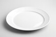 A simple white plate with a fork and knife on a table. Ideal for restaurant menus or food-related designs