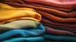 Close up shot of a pile of various colored fabrics. Perfect for textile industry or fashion design projects
