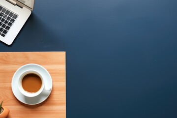 Poster - A cup of coffee and a laptop on a table. Suitable for business and technology concepts
