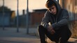 Sad depressed teenager sitting outdoors alone.

