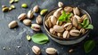 Fresh pistachios in a bowl on a dark slate background. healthy snacks concept. close-up with space for text. suitable for culinary themes. still life, food photography. AI