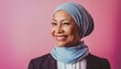 © Marko - Middle-aged woman cancer patient wearing headscarf and smiling on pink background
