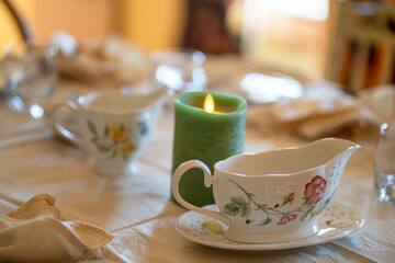 A table with a candle and two cups on it