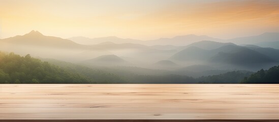 Poster - The wooden table stands in the foreground, with majestic mountains looming in the background. The sky is painted with hues of dusk, creating a stunning natural landscape