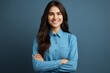 © sorin - Confident businesswoman in blue shirt smiling, professional female executive, gray background