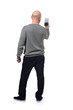 © Curto - rear view of a serious man taking a self-portrait with smartphone on white background