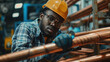A man in a hard hat and glasses working on copper pipes. Ideal for illustrating plumbing or construction concepts