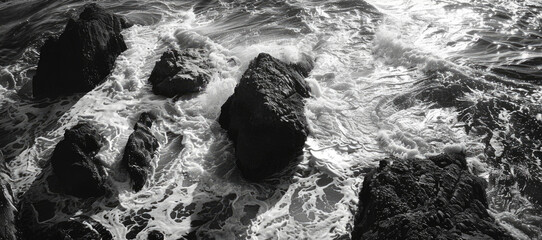 Poster - A serene black and white photo of rocks in the ocean. Suitable for various design projects