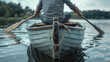 A man in a row boat on a serene lake. Suitable for outdoor and leisure concepts