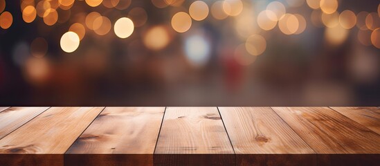 Poster - A hardwood table in a brown wood stain finish sits empty against a background of blurry Christmas lights, showcasing a beautiful pattern on the varnished plank surface