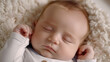 A close up of a sleeping baby on a soft blanket. Ideal for parenting blogs or baby product advertisements