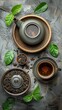 Ceramic teapot, cup with brewed tea, loose leaves, green leaves, and star anise on textured surface