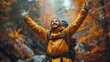 Joyful hiker with a backpack raises hands amidst a forest with vibrant autumn leaves