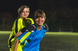© PoppyPix - Female kids, sports diversity and celebrate with friends, teamwork and goal in football. High quality photo