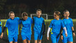 © PoppyPix - medium shot of a group of cute little girls wearing blue uniforms at the football practice at night. High quality photo