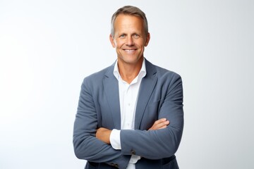 Wall Mural - Portrait of confident mature businessman with crossed arms looking at camera.